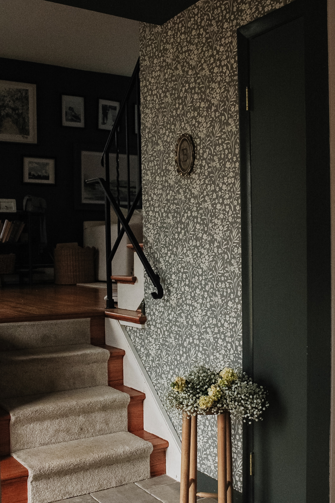 Entryway with staircase, floral wallpaper, and fresh flowers